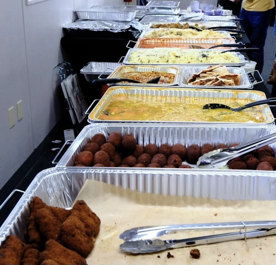 A beautifully arranged buffet with authentic Bengali dishes at a catering event